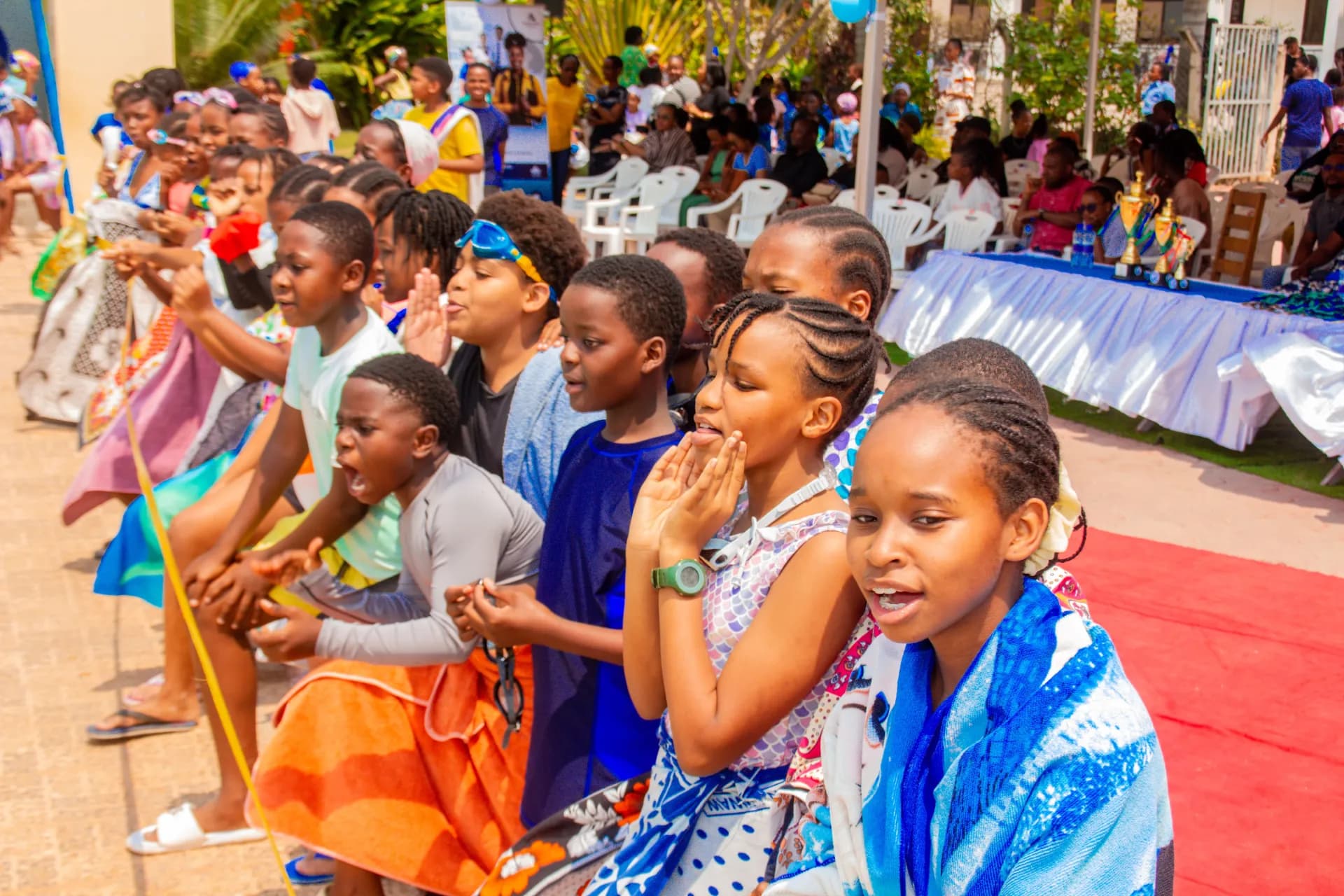 Pupils cheering for their teammates beside the swimming pool