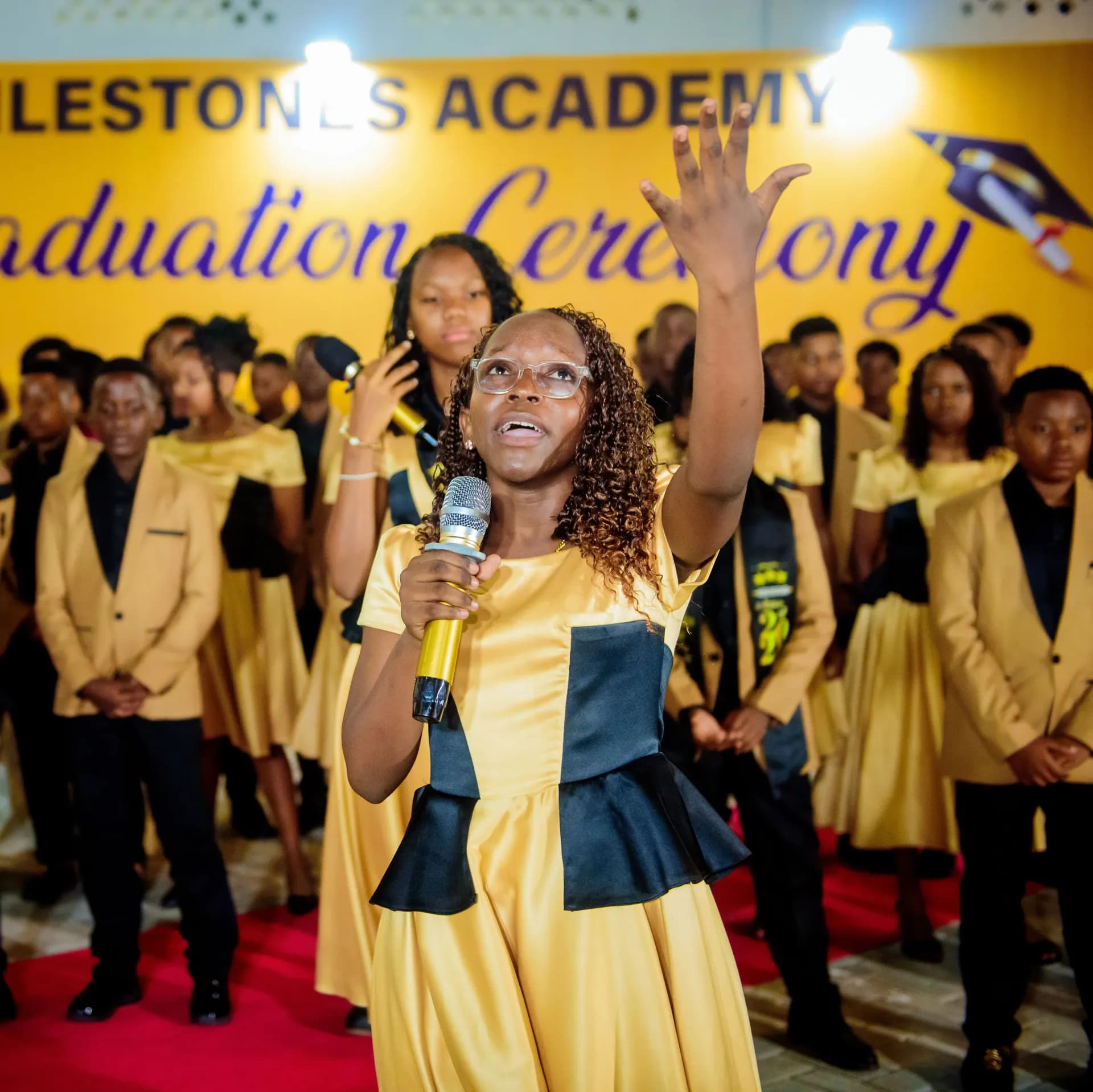 A student leading a graduation performance.