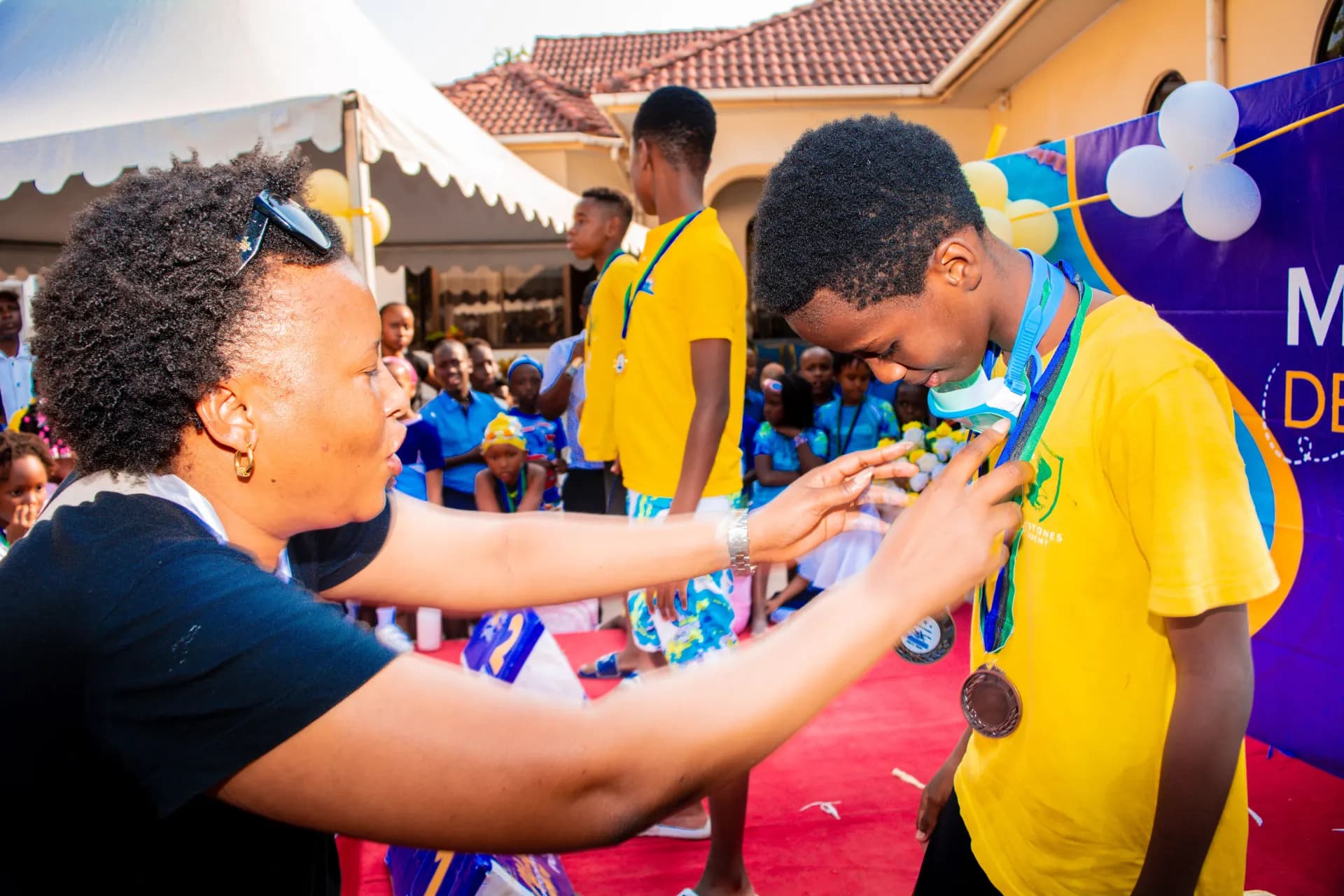 A learner receiving medals at the swimming gala.