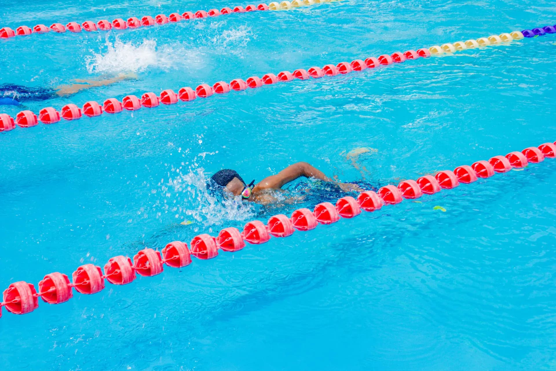 A focused swimmer racing down the lane.