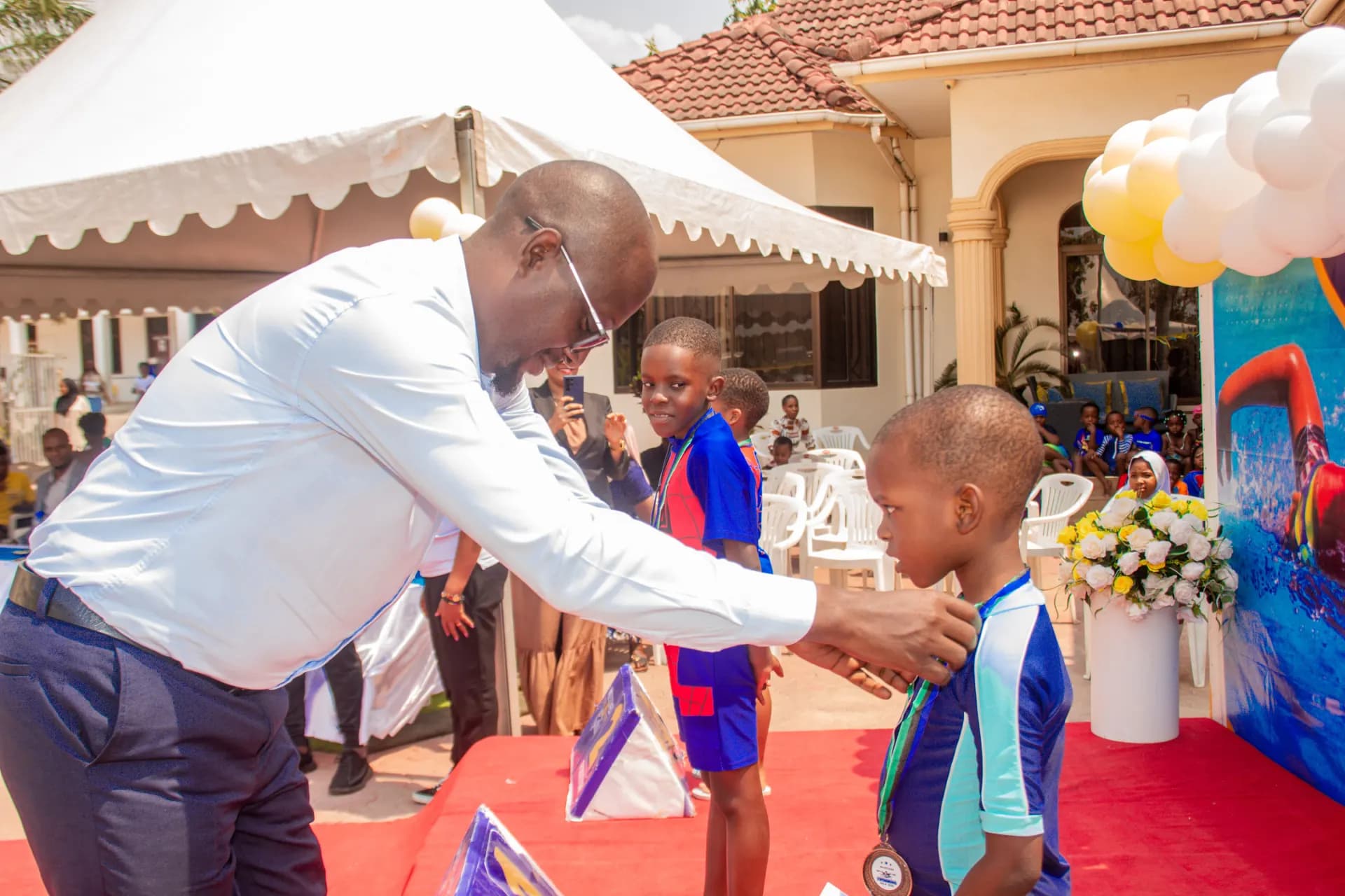 A young swimmer receives a medal.